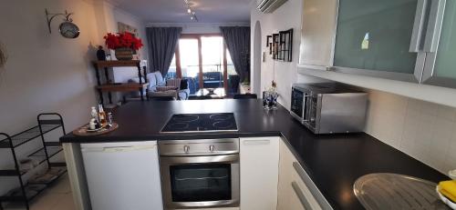 a kitchen with a stove and a counter top at Apartment AlcudiaMar in Alcudia