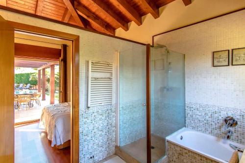 a bathroom with a shower and a tub and a bed at Catalunya Casas A Costa Brava gem - only a few minutes to the beach! in Vidreres