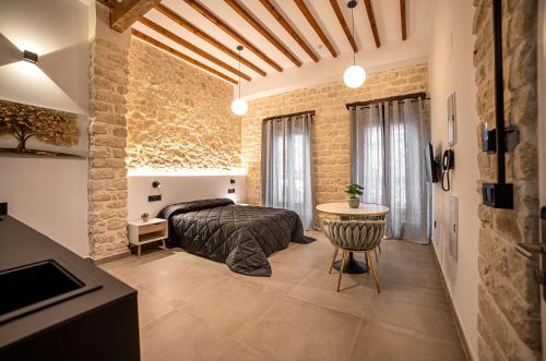 a bedroom with a bed and a table in a room at Apartamentos Loliqui centro Alicante in Alicante