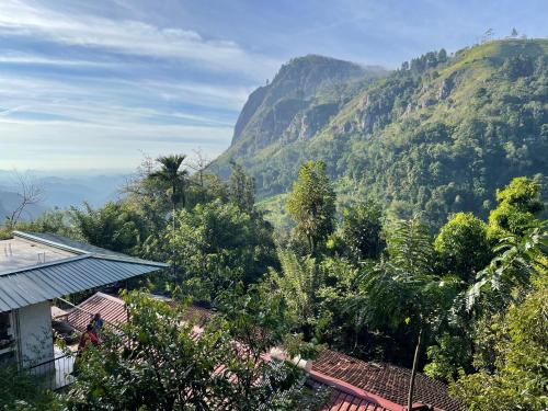 a view of a mountain with trees and a house at Country Homes in Ella