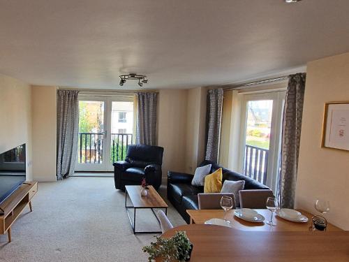 a living room with a couch and a table at Luxury Spacious Apartment- Sleeps 4 Loughborough in Loughborough