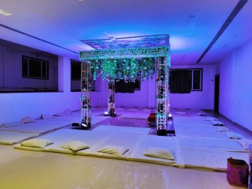 a room with a stage with white mattresses at Hotel Emperor Paradise in Bilāspur