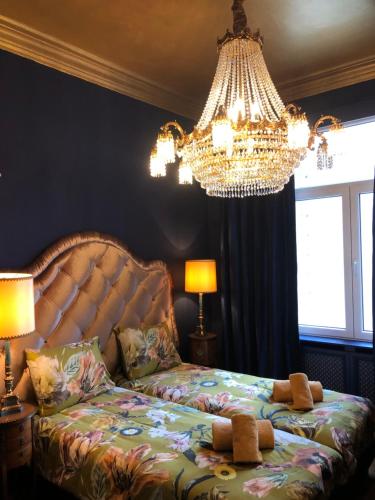 a bedroom with a bed with two teddy bears on it at Sint Andries Suites in Antwerp