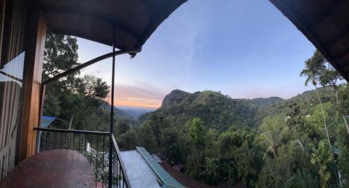 a view of the mountains from a balcony of a house at Country Homes in Ella
