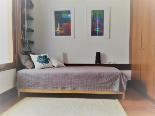 a bedroom with a bed with two pillows on it at Troia MaisMais apartamento in Troia