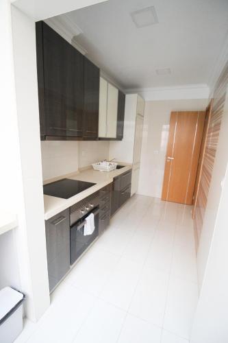 a kitchen with gray cabinets and a sink at Oriente DNA Studios V in Lisbon