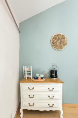 a white dresser in a room with a white wall at La Parenthèse, chambres d'hôtes in Rochegude-Drome