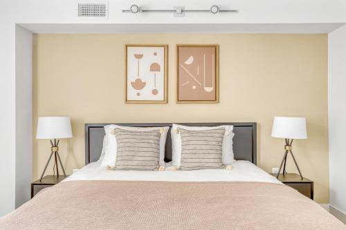a bedroom with a large bed with two lamps at Ballston 2BR w Concierge WD Pool nr Metro WDC-504 in Arlington
