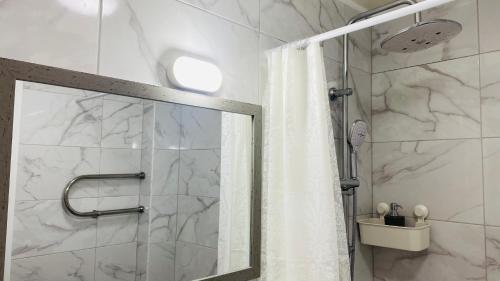a bathroom with a shower with a shower curtain at Church Hill Apartment in Daugavpils