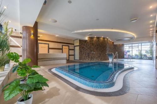 a pool in the middle of a hotel lobby at Dukat Medical Spa in Dąbki