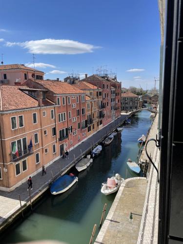 a view of a canal with boats and buildings at Casa Caburlotto in Venice