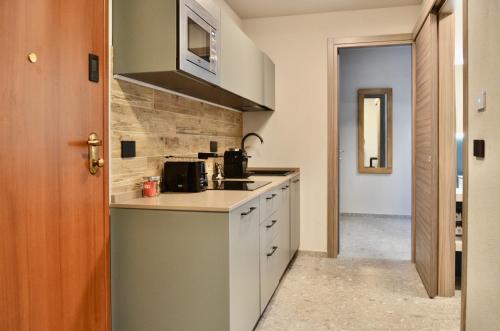 a kitchen with a sink and a counter at Apartments Du Parc in Sauze dʼOulx