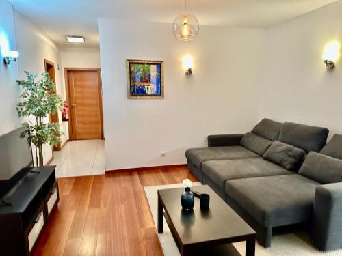 a living room with a couch and a table at Praia da Luz Mar e Sol Apartamento in Luz