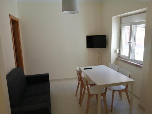 a living room with a table and chairs and a television at Oriente DNA Studios V in Lisbon