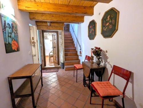 a living room with a table and chairs and stairs at La Casa Delle Fate in Siracusa