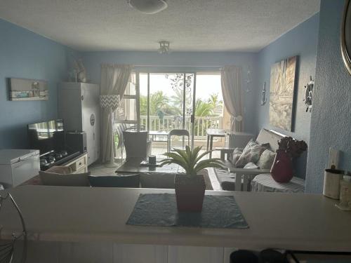 a kitchen and living room with a potted plant at 205 Laguna lacrete in Uvongo Beach