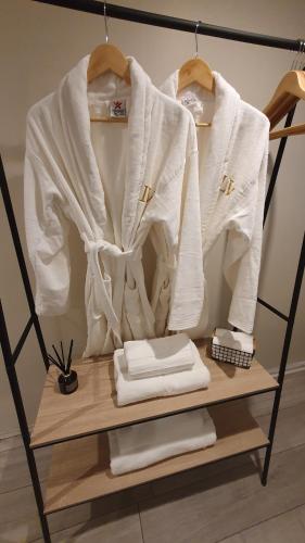 a shelf with two white sweaters on it at Lyme View Lodge in Trent Vale