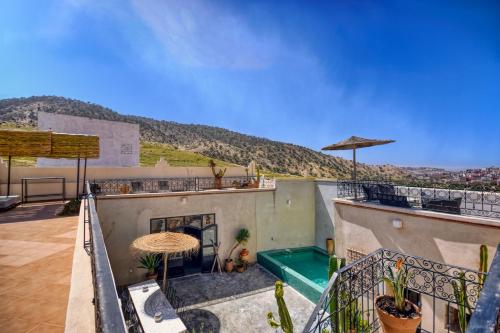 a view from the balcony of a house with a pool at Riad Amazine - Piscine - Rooftop - 6 or 7 Px in Agadir