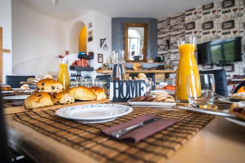 a table with bread and plates of food on it at Panacea la casa del miele in Santa Maria di Castellabate