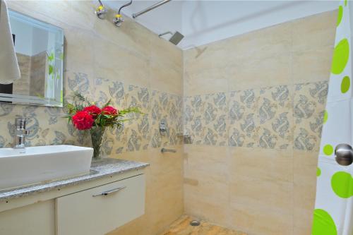 a bathroom with a sink and a shower at Dhanolti View By LA Riqueza - Centrally Located - Lift & Parking Facility in Dhanaulti