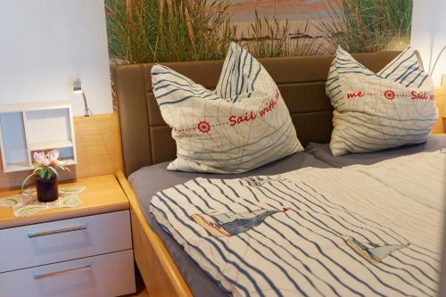 a bed with two pillows with a bird on it at Appartement "Ostseeoase" in Heiligenhafen