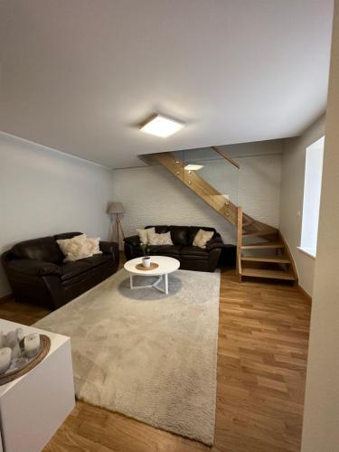 a living room with a couch and a table at Apartment Kesklinna läheduses in Tartu