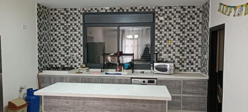 a kitchen with a sink and a mirror at Masion Lovely Home in Ramallah