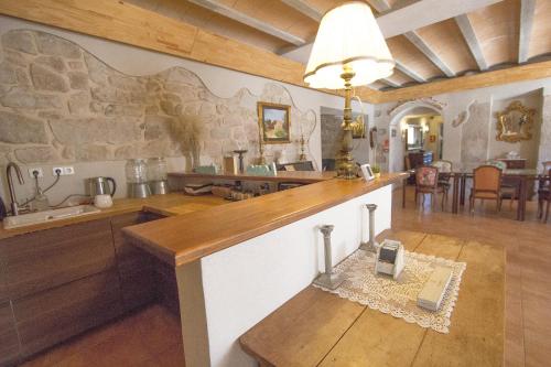 a kitchen with a counter and a stone wall at Catalunya Casas Wow! Boutique hotel converted into a private villa! in Rubio