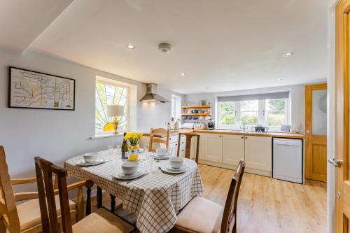 a kitchen and dining room with a table and chairs at Bar Lane Cottage - Norfolk Cottage Agency in Reepham