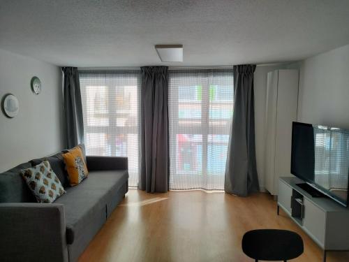 a living room with a couch and a television at La Paz in Almansa