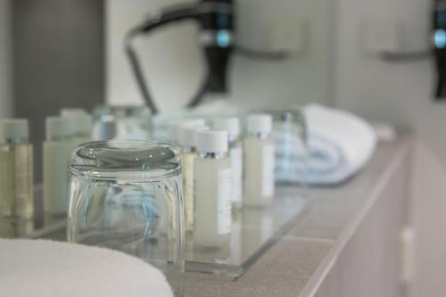 a glass counter top with a bunch of bottles on it at Bayer 89 Vi Vadi Hotel in Munich