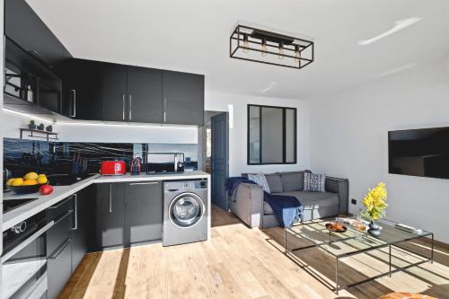 a kitchen and living room with a washer and dryer at Sea view - 5min Monaco - Swimming pool in Cap d'Ail