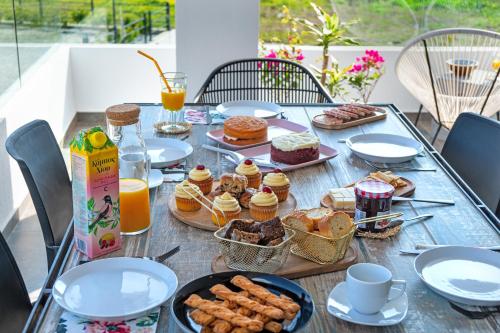 a table with breakfast foods and drinks on it at Mythos Luxury Villa-Skiathos in Troulos