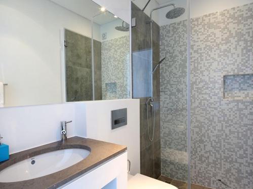 a bathroom with a sink and a glass shower at Luxurious Algarve Villa Villa Manou 5 Bedrooms Private Heated pool 300m from the Beach Carvoeiro in Carvoeiro