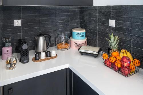 a kitchen counter with a fruit basket on it at Mythos Luxury Villa-Skiathos in Troulos