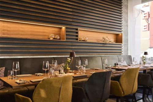 a dining room with wooden tables and chairs at Hotel Platzhirsch in Fulda