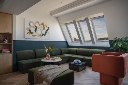 a living room with a couch and a table at Almanac X Alcron Prague in Prague