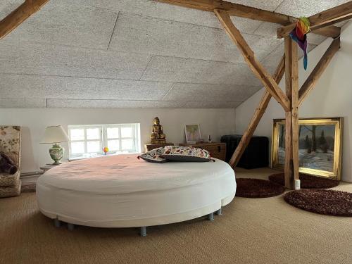 a bedroom with a large white bed in a room at Rainbows End B&B in Sorø