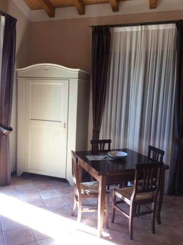 a dining room with a black table and chairs at Locanda dei Rii in Manerba del Garda