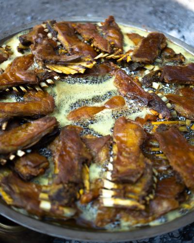 a close up of a pizza with bacon on it at The Khyber Himalayan Resort & Spa in Gulmarg