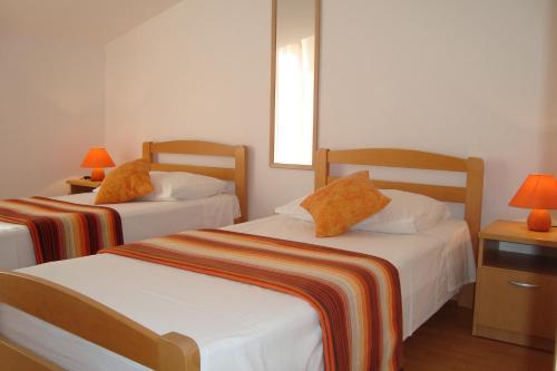 Postel nebo postele na pokoji v ubytování Apartments Bulicic