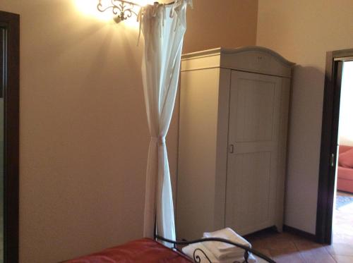 a room with a bed with a white curtain at Locanda dei Rii in Manerba del Garda