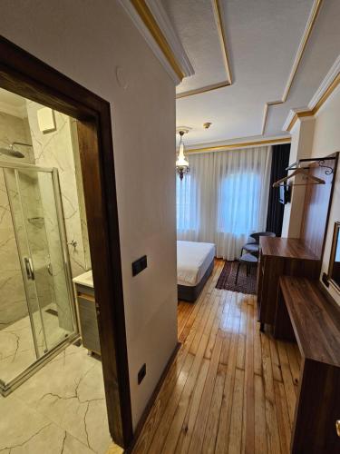 a hotel room with a bed and a bathroom at Gul Sultan Hotel in Istanbul