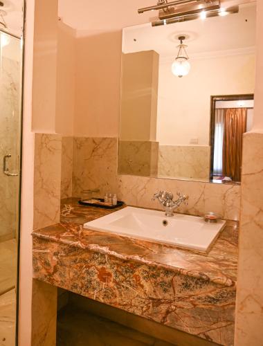 a bathroom with a sink and a mirror at Ranbanka Palace in Jodhpur