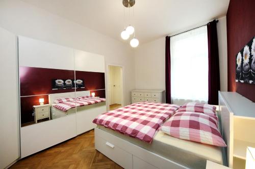 a bedroom with a bed and a large window at Historic Centre Apartments V in Prague
