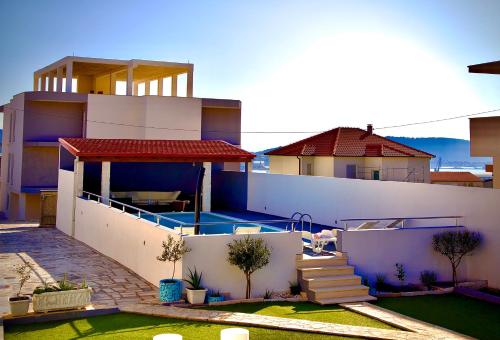 a house with a swimming pool in front of it at Villa Ana in Kastel Sucurac