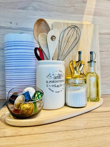 a cutting board with a kitchen utensils and a mortar and pestle at Apt Ljupka - Zadar - with private free parking in Zadar