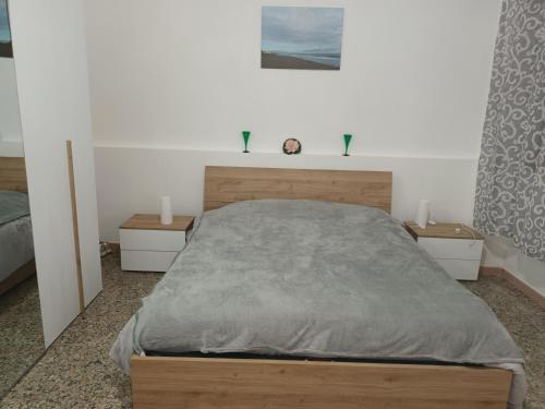 een slaapkamer met een groot bed en 2 nachtkastjes bij SIRENETTA in Carlentini