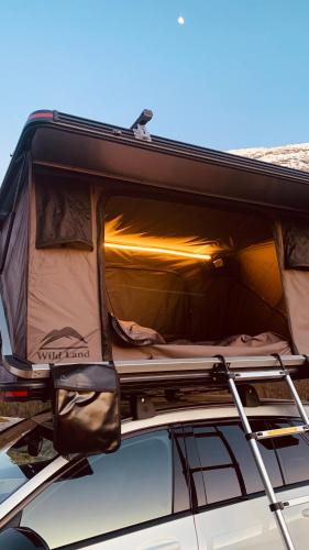 una macchina con un camper sopra di Rent Rooftop tent for car with roofrack a Stavanger
