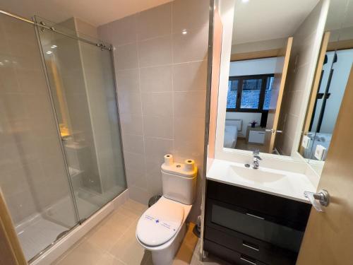 a bathroom with a toilet and a shower and a sink at Apartamentos Princesa Park 3000 in Pas de la Casa